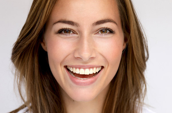 Beautiful woman smiling after dental bonding procedure at San Francisco Dental Arts