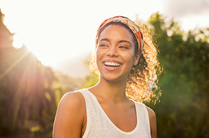 Beautiful Black woman smiling after making a holistic dentist appointment at San Francisco Dental Arts in San Francisco, CA