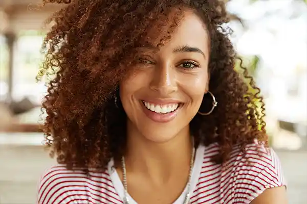 Close up shot of beautiful woman smiling because of her new smile by San Francisco Dental Arts in San Francisco, CA