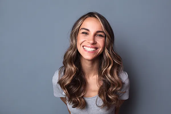 Joyful white woman showing off her beautiful teeth and fillings with a smile at San Francisco Dental Arts in San Francisco, CA