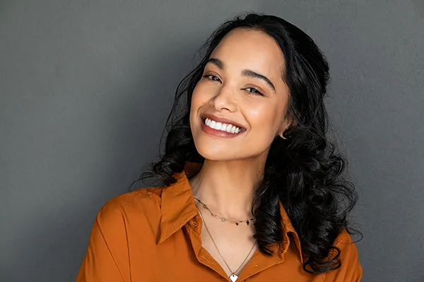 Beautiful Hispanic woman showing off her smile from teeth whitening at San Francisco Dental Arts in San Francisco, CA