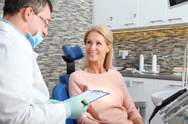 Woman talking to dentist in San Francisco, CA