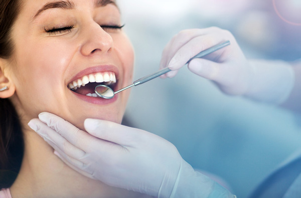 Woman getting dental exam and receiving periodontal maintenance at San Francisco Dental Arts in San Francisco, CA