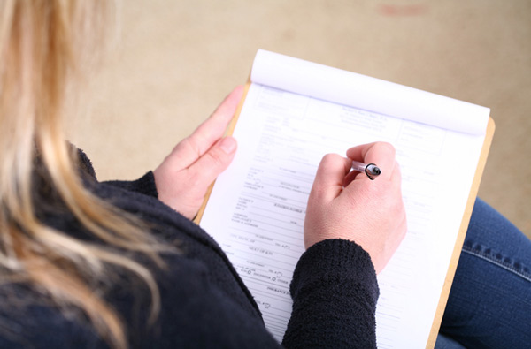 Woman filling out insurance paperwork for San Francisco Dental Arts in San Francisco