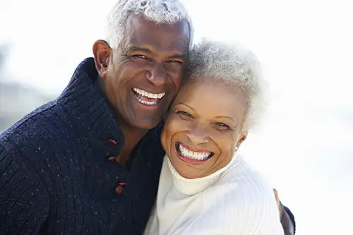 Close up of older couple smiling and hugging at San Francisco Dental Arts in San Francisco, CA